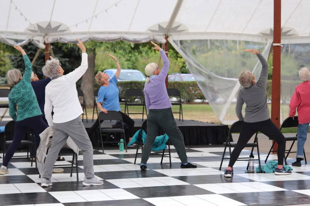 People exercising under tent outdoors
