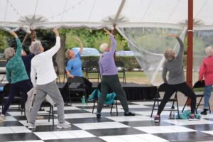 People exercising under tent outdoors