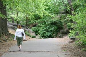 Hiking in Greenport 1 Woman walking on trail in forest