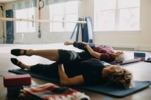 Two women doing yoga on mats in Greenport, NY