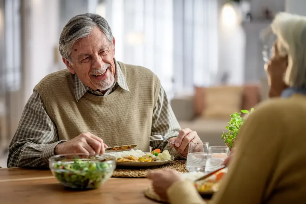 Wellness Uncovered: The Power of Whole-Person Wellness for Seniors 2 Couple eating at table