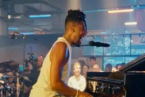 Jon Batiste sings on stage