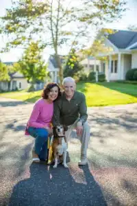 Blog 2 A couple poses with their dog outside