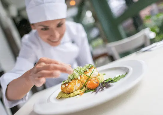 Chef adding Garnish to a dish